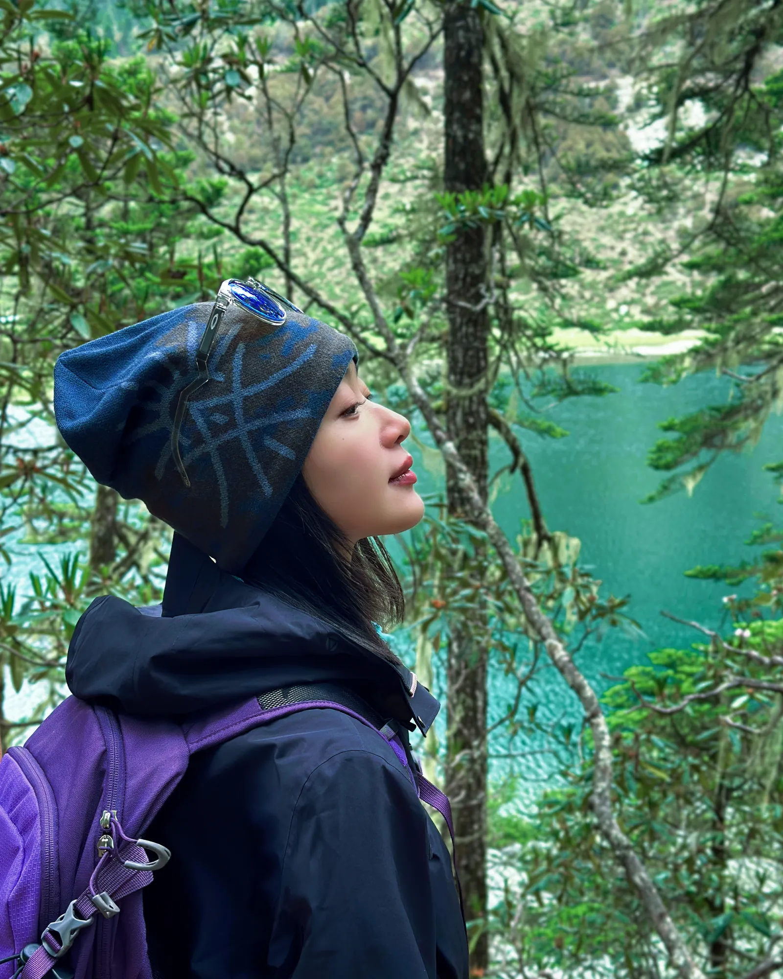 Chloe hiking beside an alpine lake in Yunnan